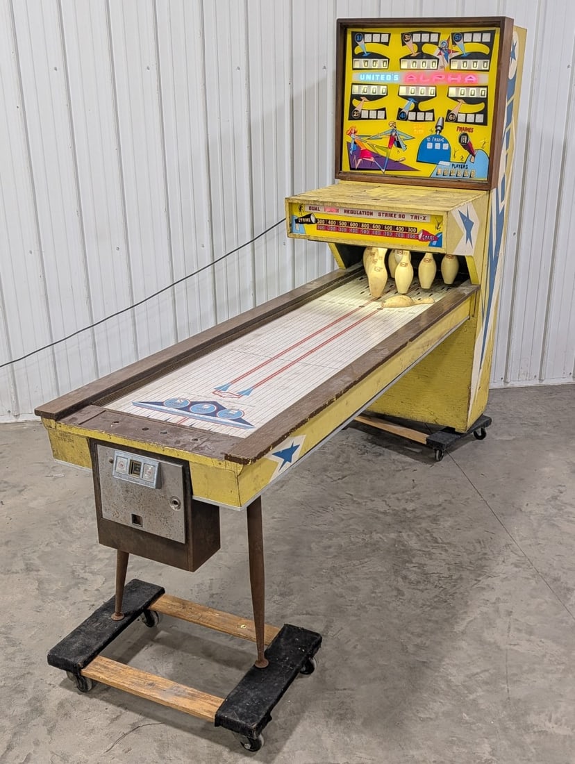 Vintage Williams United's Alpha Bowling Coin Op Arcade Game: Vintage Williams brand United's Alpha coin operated bowling arcade game. Fair cosmetic condition with paint loss, surface rust, moisture damage, and other wear from use and age. Powers on but will nee