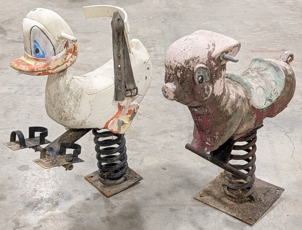 Vintage Duck and Pig Playground Spring Rides: Vintage cast metal duck and pig playground spring rides. The duck is unique because it has a backrest with belt and feet mounts. Both are in uncleaned as found condition. Both show paint loss and wear