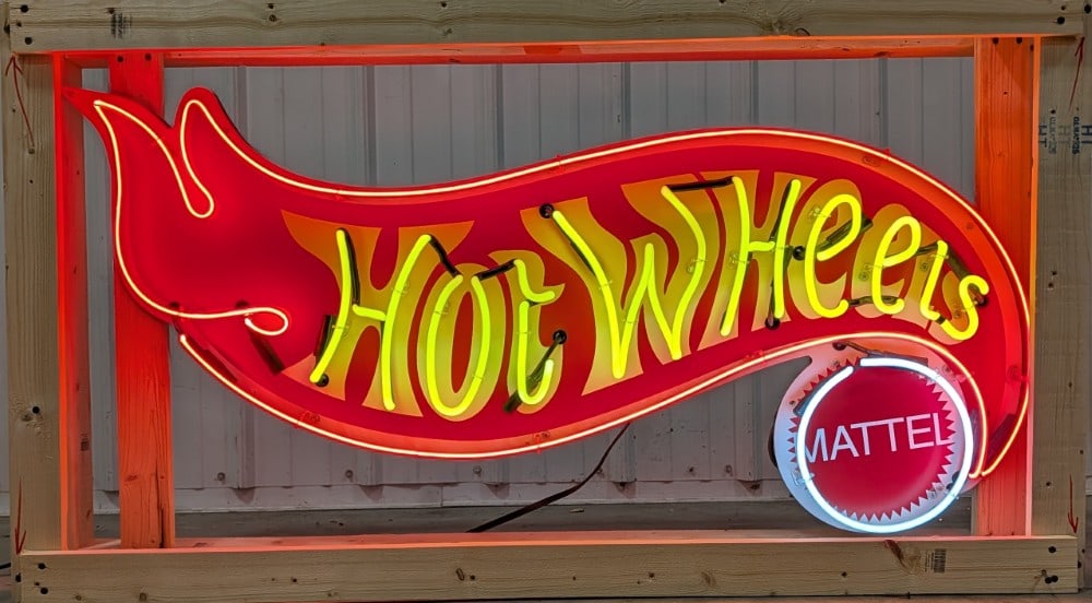 4ft Custom Mattel Hot Wheels Neon Sign: Custom single sided Hot Wheels neon sign with flashing neon "Hot Wheels" letters. It features a custom made Hot Wheels sign mounted on a piece of plywood with new neon and transformer. Appear sto be i