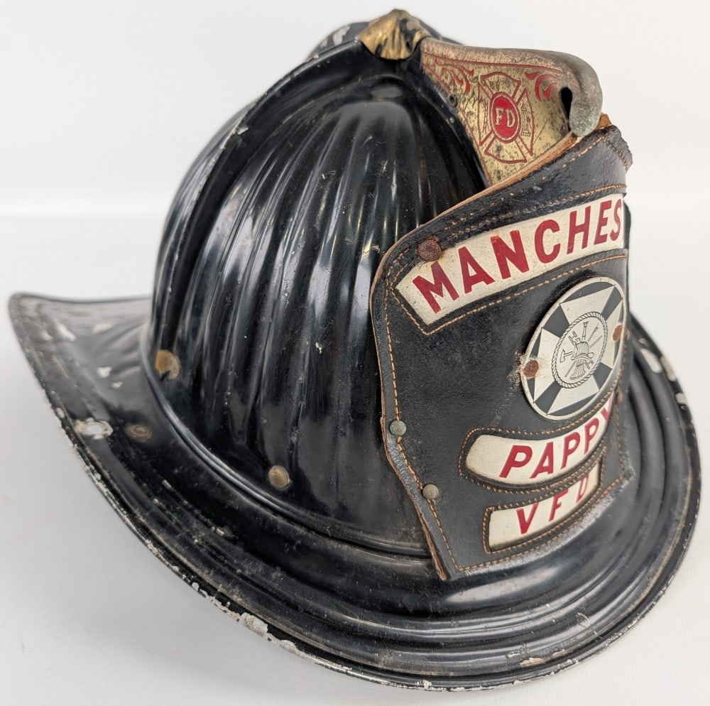 Vintage Cairns & Brother Metal Manchester Fire Helmet w/ Leather Badge: Vintage Cairns & Brother Manchester Fire Department fireman's helmet with leather badge. Has paint loss, plate loss on eagle, weathering to leather badge,? and other wear from use and age.