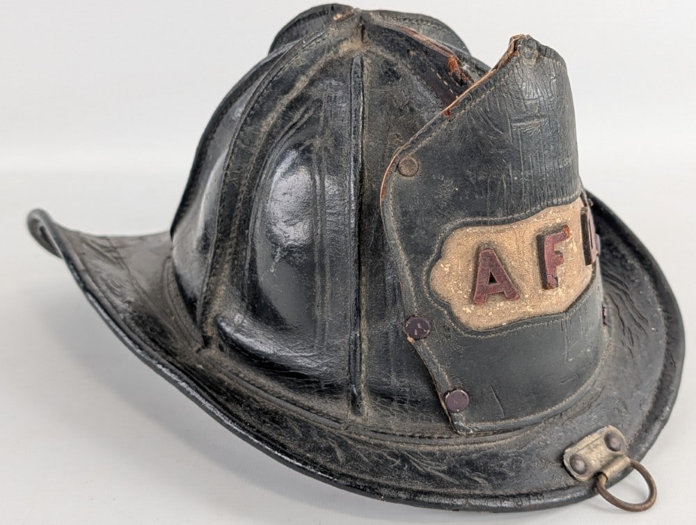 Early Cairns & Brother All Leather AFD Fire Department Fireman's Helmet w/ Leather Badge: Early Cairns & Brother AFD Fire Department fireman's helmet with leather badge. Has weathering to Leather, discoloration, and other wear from use and age. Displays well with a great look. Marked a