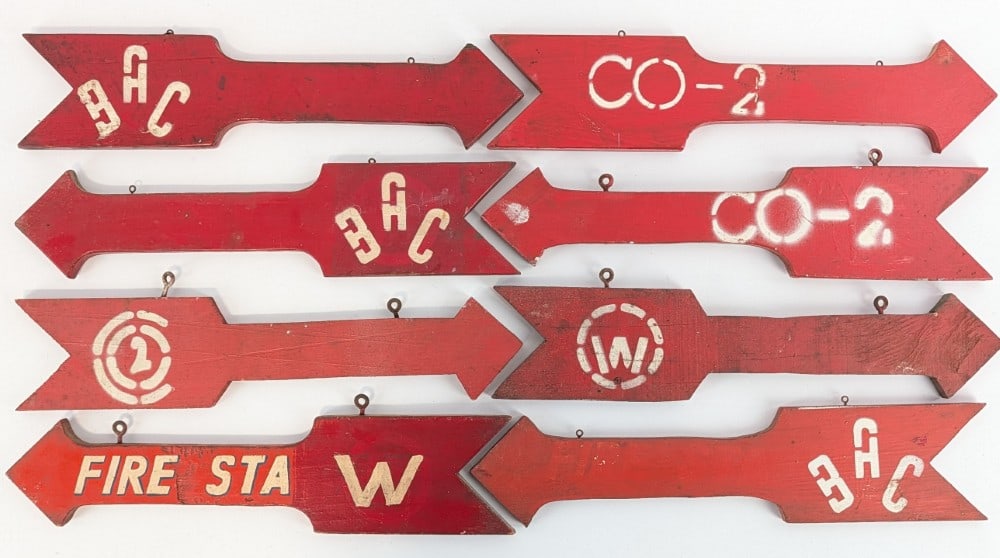 8) Vintage 2-Sided Wood Fire Station Arrow Signs: Lot of eight vintage double sided wood fire station hand painted arrow signs. They have paint loss, discoloration, and other wear from use and age. Some of the arrows you can see there are multiple la