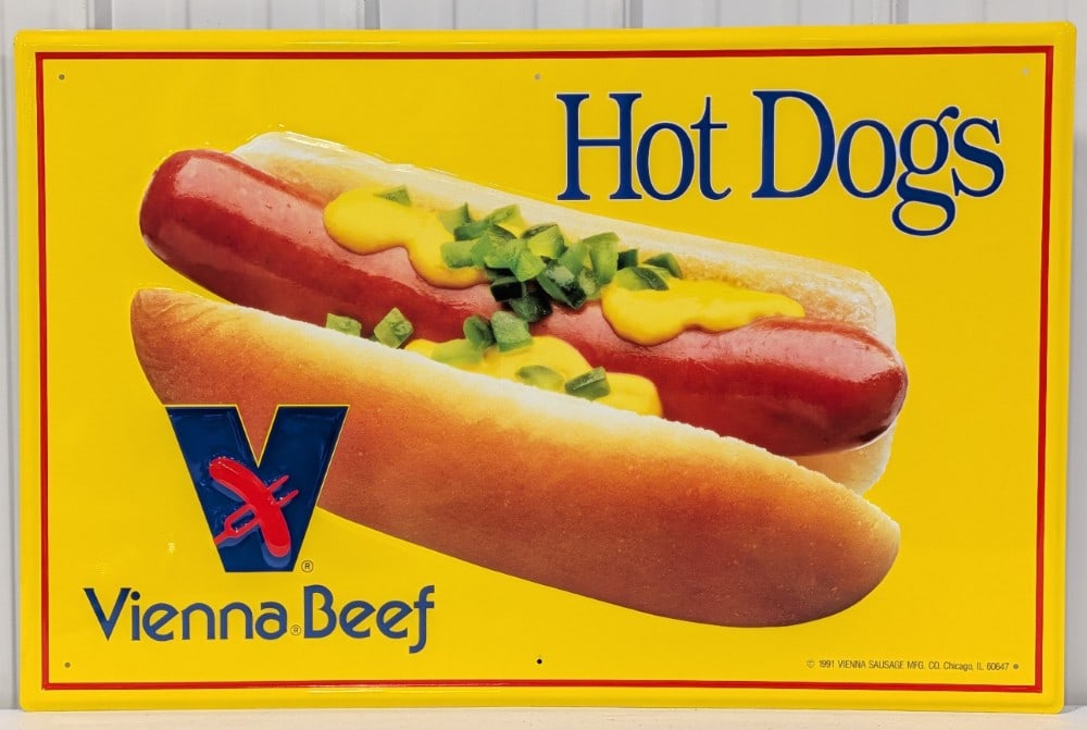 SST Vienna Beef Hot Dogs Embossed Sign: Single sided embossed metal Vienna Beef Hot Dogs advertising sign. Appears to be in excellent condition with light wear from storage. It measures approximately 35in across 23in tall.