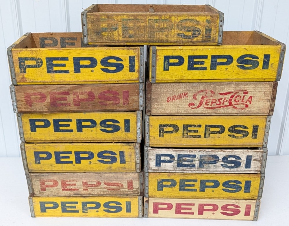 13) Vintage Pepsi-Cola Wooden Soda Crates: Lot of thirteen vintage Pepsi-Cola wooden soda crates. They vary in condition with paint loss l, damage, and wear form use and age. Display well