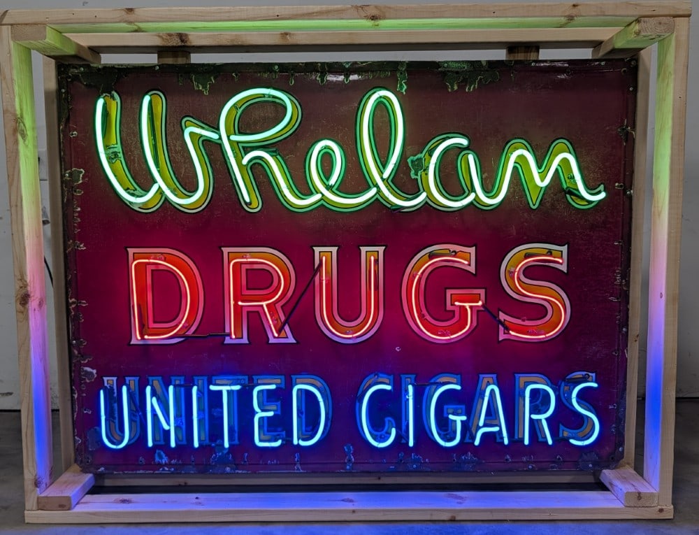 5ft Vintage SSP Whelam Drugs United Cigars Neon Sign: Vintage single sided porcelain Whelam Drugs United Cigars neon advertising sign. It features an original single sided porcelain sign with newly added neon and can. Sign has porcelain loss and wear for