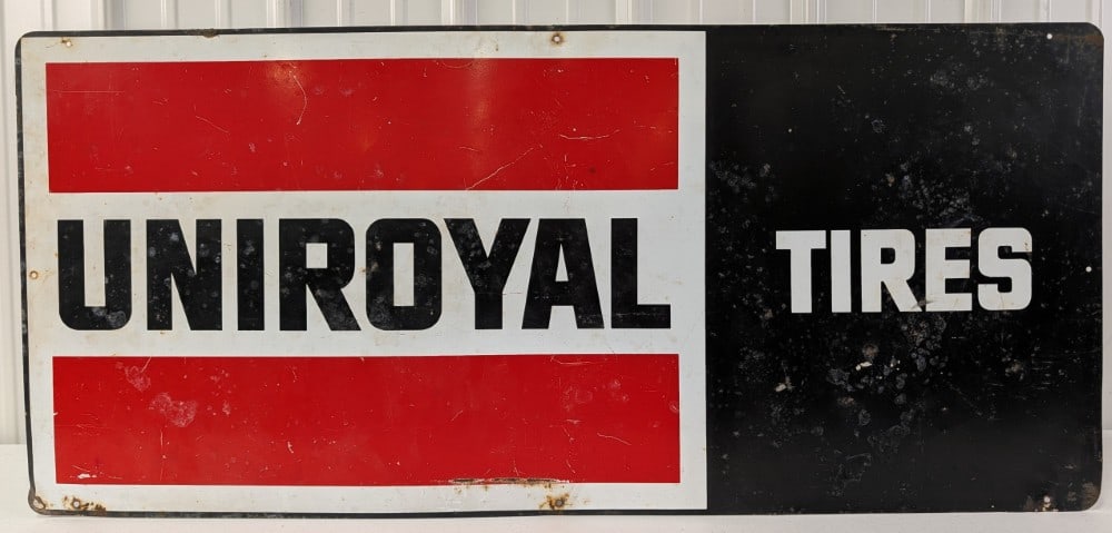 Vintage SST Uniroyal Tires Advertising Sign: Vintage single sided metal Uniroyal Tires advertising sign. Has paint loss, surface rust, scratches, and wear from use and age. Measures approximately 40in across by 18in tall