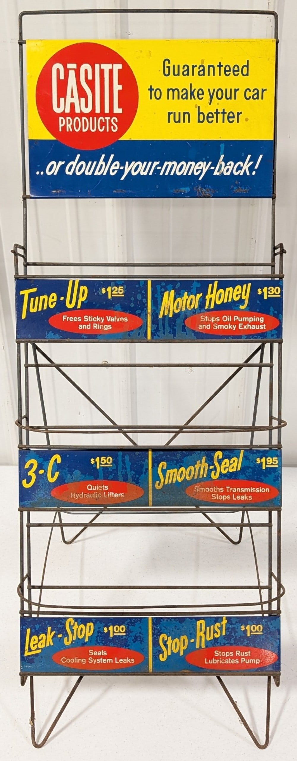 Vintage Casite Oil Treatment Metal Store Display Rack: Vintage Casite oil treatment store display metal rack. Has paint loss, surface rust, discoloration, and other wear form use and age. It measures approximately 34in tall by 13-1/2in across