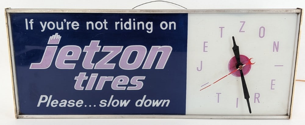Vintage Jetzon Tires Lighted Advertising Clock: Vintage Jetzon Tires Lighted advertising clock. Has paint loss, scratches, fading, discoloration, a few chips on one of the white plastic end caps, and other wear from use and age. Does not currently