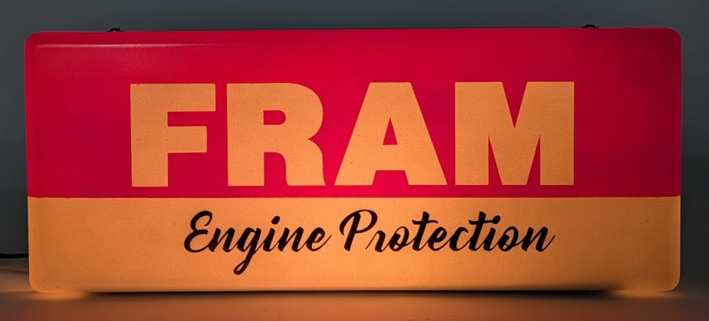 Custom Fram Engine Protection Lighted Advertising Sign: Custom Fram Engine Protection lighted countertop advertising sign. The metal can has been repainted as well as the plastic sign lens with decals applied. The sign still displays well with a good