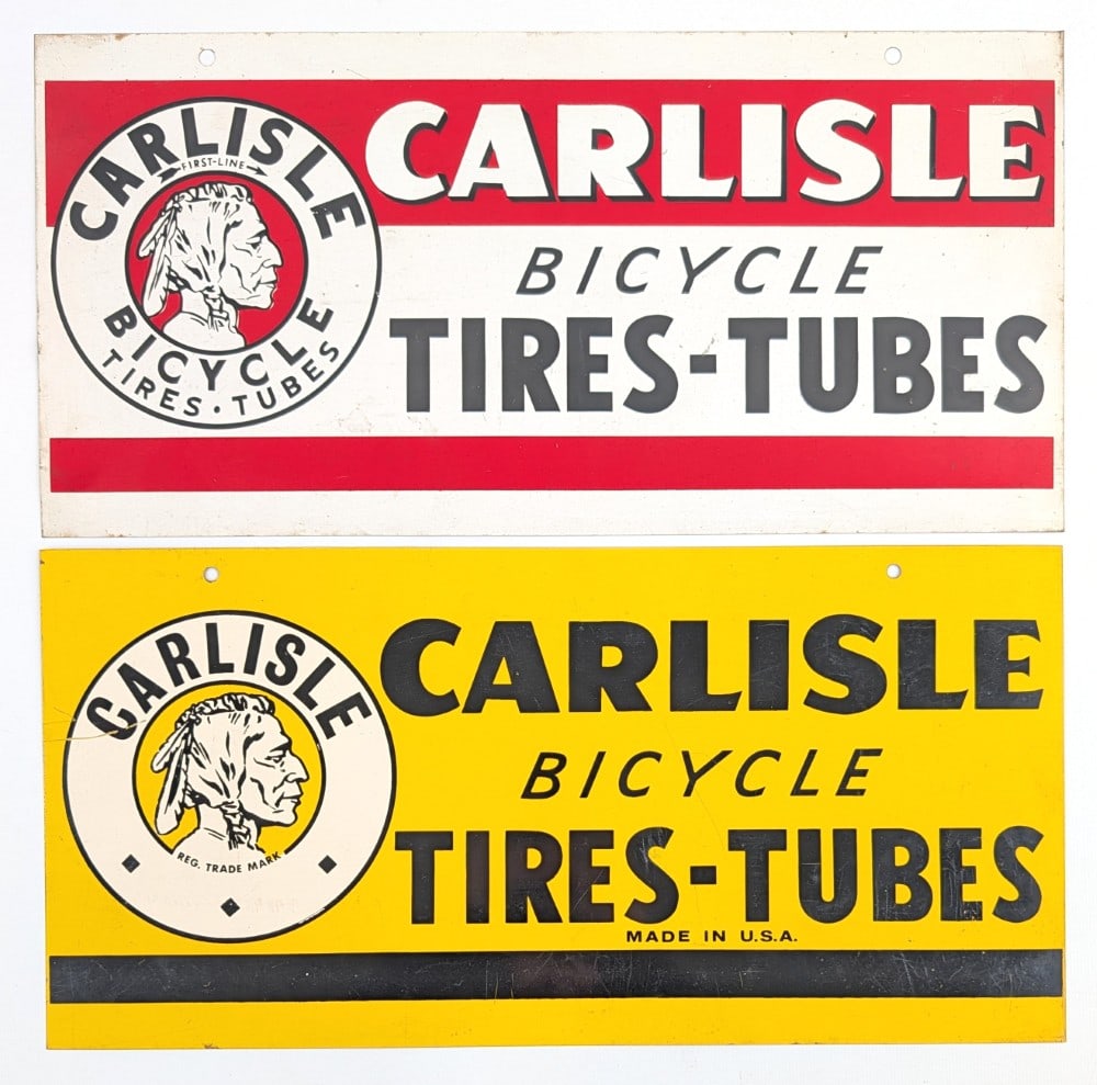 (2) SST Carlisle Bicycles Tires - Tubes Advertising Signs: (2) Single sided tin Carlisle Bicycles tires - tubes advertising signs with Indian graphics. The signs have scratches, rub marks, and wear from storage and display. Each measures approximately 16"