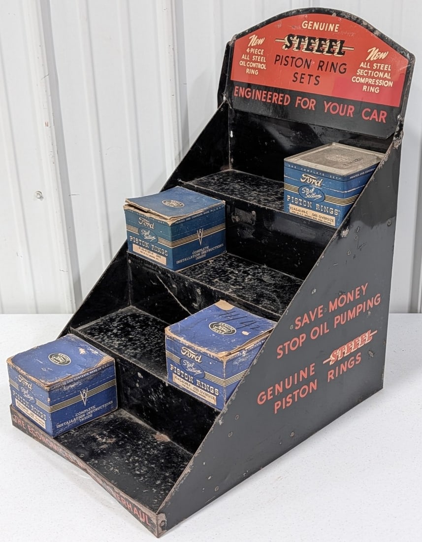 Vintage Steel Piston Rings Metal Countertop Store Display Rack: Vintage Steel Piston Ring Sets metal countertop store display with four boxes of Ford Piston rings. Displays has paint loss, surface rust, dents, and other wear from use and age. It measures approxima
