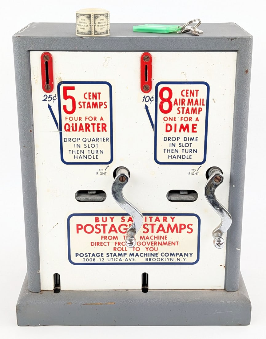 Vintage Postage Stamps Coin Operated Vending Machine: Vintage Postage Stamps coin opered vending machine by the Postage Stamp Machine Company. The machine shows some scratches, paint loss, and wear from use and age. The machine comes with the keys and a