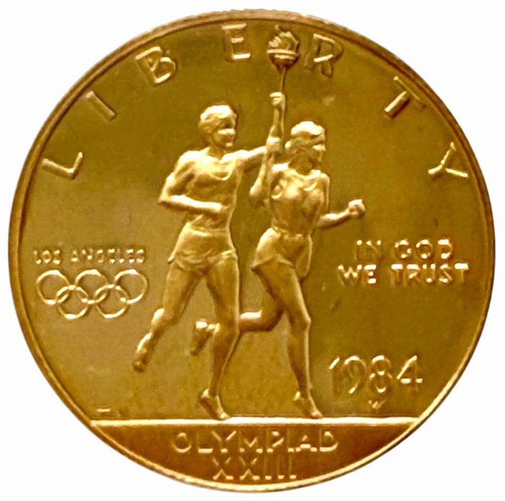 1984-W United States $10 Olympiad XXIII Commemorative Gold Proof Coin: 1984-W United States $10 Olympiad XXIII Commemorative Gold Proof Coin. The coin contains .4847 troy ounce of .999 pure gold. Comes in capsule.