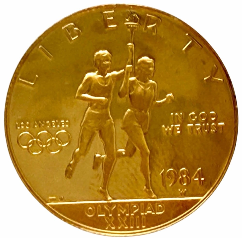 1984-W United States $10 Olympiad XXIII Commemorative Gold Proof Coin: 1984-W United States $10 Olympiad XXIII Commemorative Gold Proof Coin. The coin contains .4847 troy ounce of .999 pure gold. Comes in capsule.