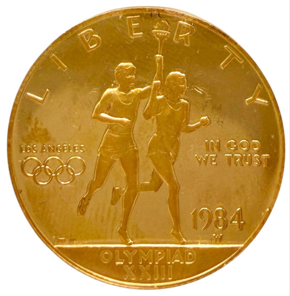 1984-W United States $10 Olympiad XXIII Commemorative Gold Proof Coin: 1984-W United States $10 Olympiad XXIII Commemorative Gold Proof Coin. The coin contains .4847 troy ounce of .999 pure gold. Comes in capsule.