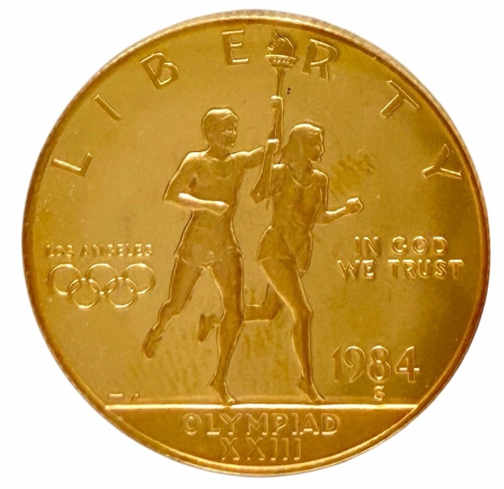 1984-S United States $10 Olympiad XXIII Commemorative Gold Proof Coin: 1984-S United States $10 Olympiad XXIII Commemorative Gold Proof Coin. The coin contains .4847 troy ounce of .999 pure gold. Comes in capsule.