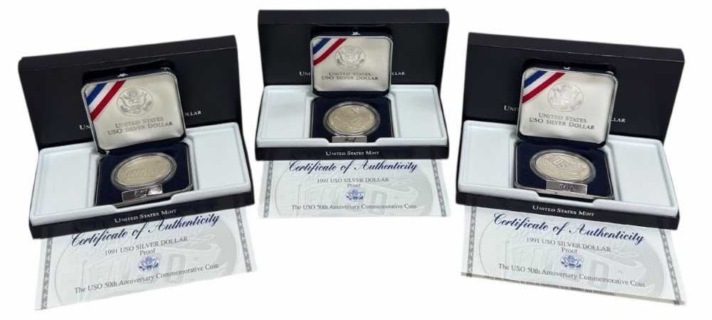 (3) U.S. Mint 1991 USO 50th Anniversary Commemorative Proof Silver Dollars: (3) U.S. Mint 1991 USO 50th Anniversary Commemorative Proof Silver Dollars. The coins are in new condition in the original box with paperwork. Each dollar is 90% silver and contains .7734 troy ounce o