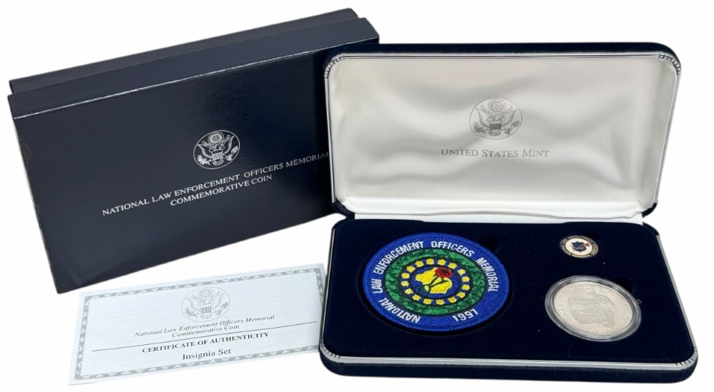 1997 U.S. Mint Law Enforcement Officers Memorial Commemorative Proof Silver Dollar Insignia Set: 2000 U.S. Mint Law Enforcement Officers Memorial Commemorative Proof Silver Dollar Insignia Set. The set includes the proof Law Enforcement Officers Memorial Commemorative Silver Dollar, lapel pin and