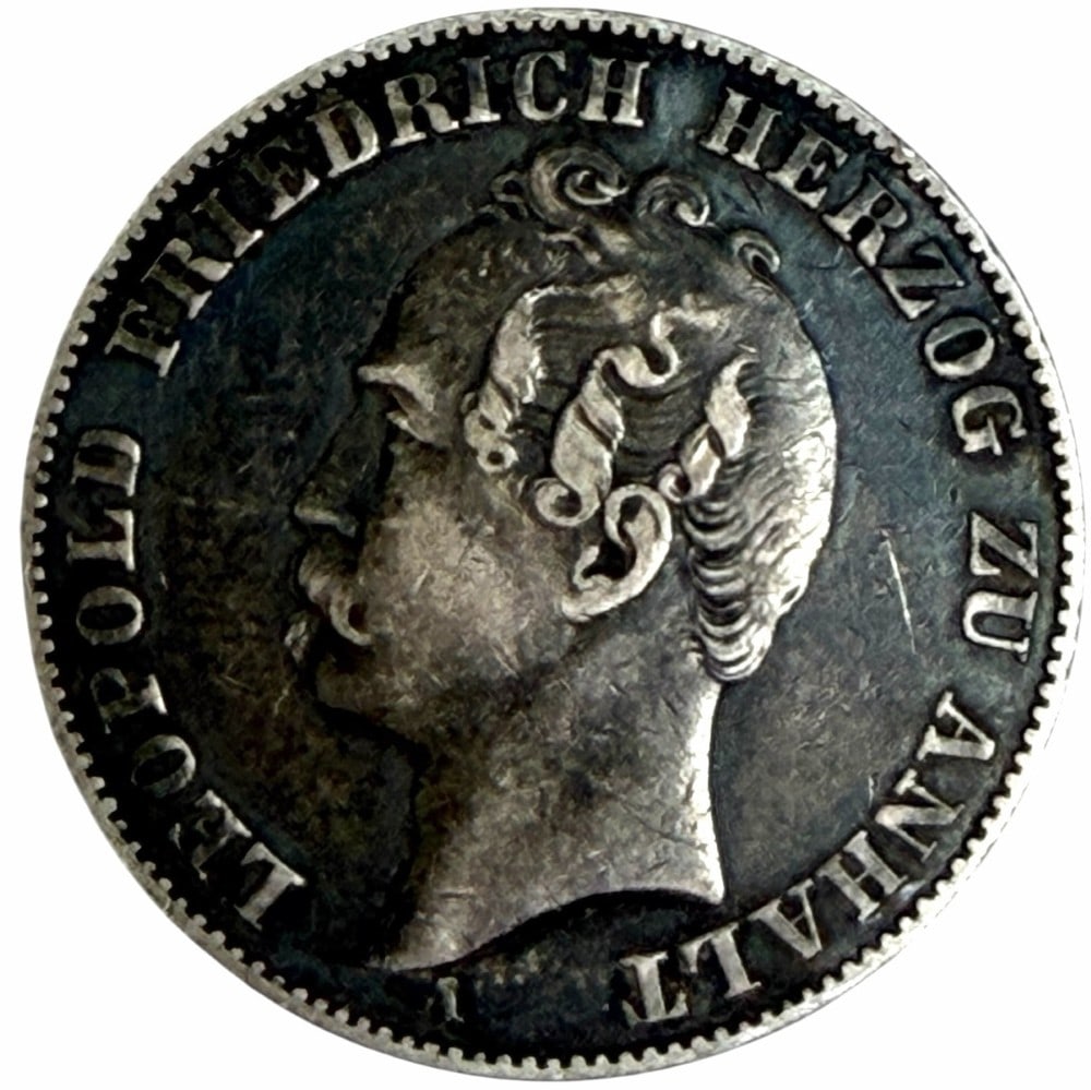 1858-A German States Anhalt-Dessau Silver Thaler: 1858-A German States Anhalt-Dessau Silver Thaler. The coin is 90% silver. Better condition circulated toned coin.