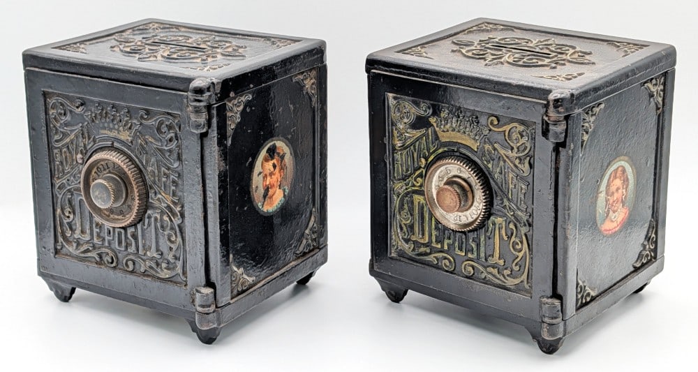 (2) Cast Iron Royal Safe Deposit Banks: (2) Early cast iron Royal Safe deposit banks The banks are painted in black overall with gold lettering. The one has baby graphics and the other has young girl graphics on the side panels. The banks m