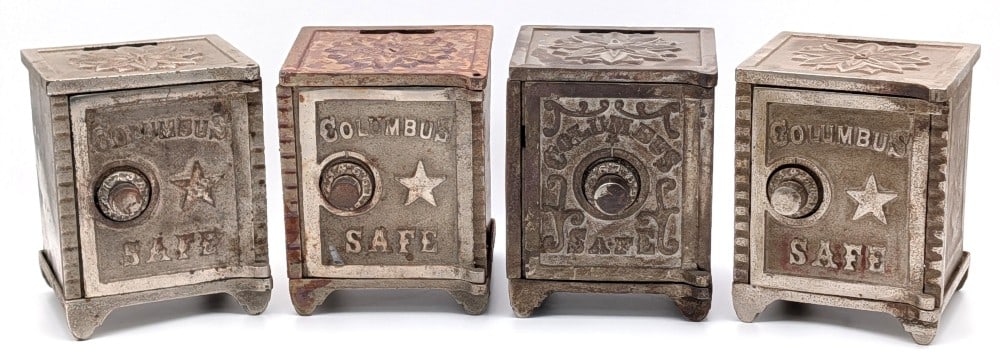 (4) Cast Iron Columbus Safe Banks: (4) Cast iron Columbus Safe still banks. Two of the banks have the combos written on the bottom and the others are unknown. The banks show plating loss and wear from use and age. Each measures approxi