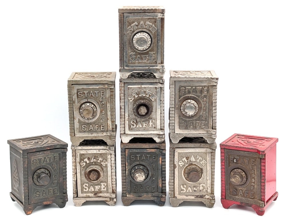 (9) Cast Iron State Safe Banks: (9) Cast Iron State Safe banks. The banks all show either paint loss or plating loss and wear from use and age. Unknown combinations. Each measures approximately 4" tall by 2-3/4" deep by 2-3/4" acros