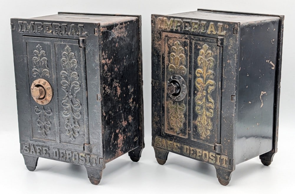 (2) Cast Iron Imperial Safe Deposit Still Banks: (2) Cast iron and tin sheet metal Imperial Safe Deposit still banks. No combinations included. Both show paint loss and wear from use and age. Each measures approximately 8-3/4" tall.