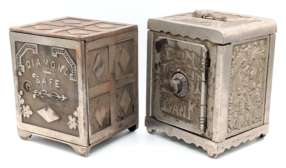 Cast Iron Coin Deposit Bank and Diamond Safe Still Banks: Cast iron Coin Deposit Bank and Diamond Safe still banks. The banks show plating loss and wear from use and age. The one has a dial combo and the other has a keyed door. No key included, but is unlock