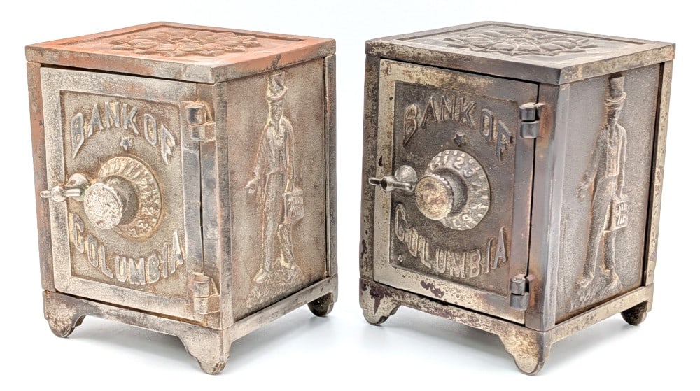(2) Cast Iron Bank of Columbia Safe Still Banks: (2) Cast iron Bank of Columbia safe still banks. The banks have plating loss and wear from use and age. No combinations included. Each measures approximately 4-3/4" tall.