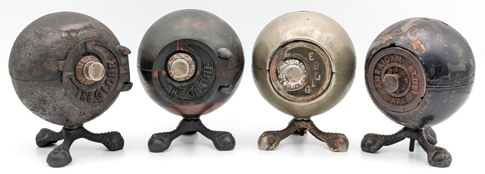 (4) Cast Iron "The Globe" Cast Iron Safe Still Banks: (4) Cast Iron "The Globe" cast iron safe still banks. None of them have the combinations, but two are currently opened. the banks show paint loss, plating loss, and wear from use and age. A great coll