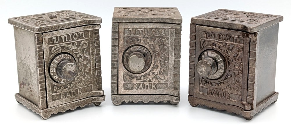 (3) Kenton Brand Cast Iron Union Bank: (3) Kenton Brand cast iron Union Bank still safe bank. The banks are all locked with no combinations. All show plating loss and wear from use and age. Each measures approximately 3-1/4" tall.?