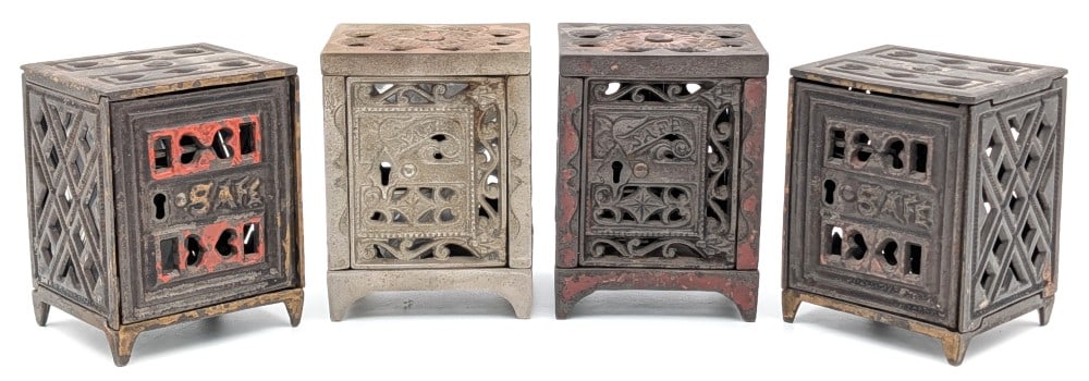 (4) J&E Stevens Cast Iron Safe Still Banks: (4) J&E Stevens cast iron slotted still safe banks. The banks show paint loss and wear from use and age. Two of them have keys and the others are locked. Each measures approximately 3" tall.