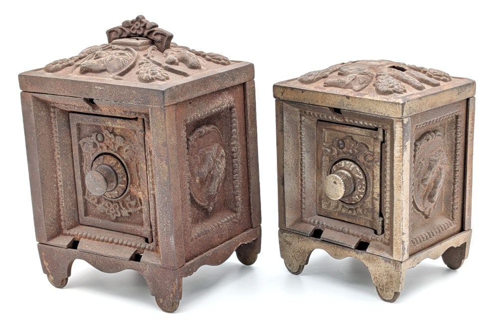 (2) Kenton Brand Cast Iron Safe Still Banks: (2) Kenton Brand cast iron safe still banks. Both banks are missing the barred doors and the smaller one is missing the handle. The bigger one is open and the smaller one is locked. No combinations fo