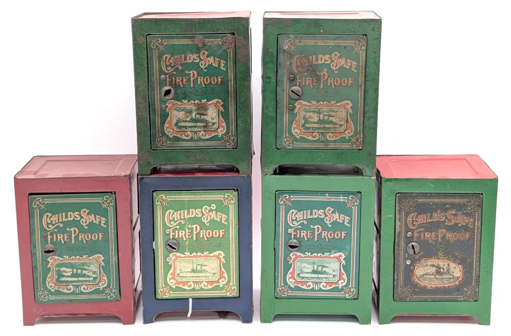 (6) Child's Safe Fire Proof Tin Banks: (6) Vintage Child's Safe Fire Proof banks. Comes with one key that works for some, but not all. The banks show discoloration, scratches, and wear from age. Displays well with good graphics and patina.