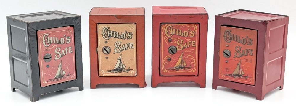(4) Child's Safe Tin Banks w/ Sailboat Graphics: (4) Vintage Child's Safe tin banks with sailboat graphics. Two of the banks come with keys. The banks show scratches, discoloration, and wear from use and age. Each measures approximately 3-3/4" tall.