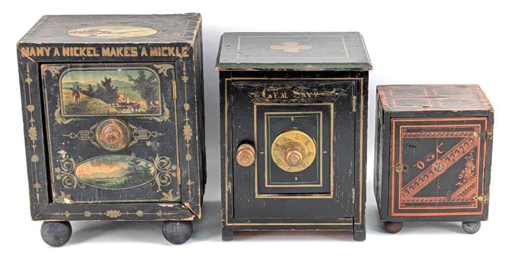 (3) Early Paper Lithograph Over Wood Safe Banks: Includes Many A Nickel Makes A Mickle, "O C" safe, and Gem Safe. The Nickel bank is missing the rolling wheels and was replaced with ball feet. The "O C" bank is the same way missing the rolling wheel