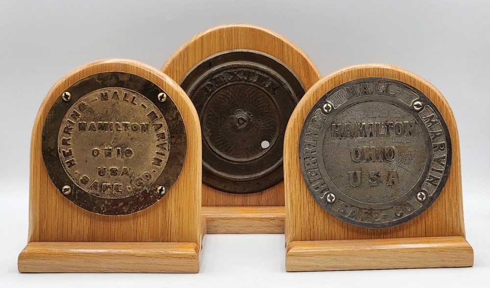 3 Cast Metal Safe Mechanism Door Plaques Mounted On Wooden Stands: Brands include Herring-Hall-Marvin Safe Co and Dexter. Light wear on metal due to age and handling. Biggest stand measures approximately 7" X 4_" X 7_"
