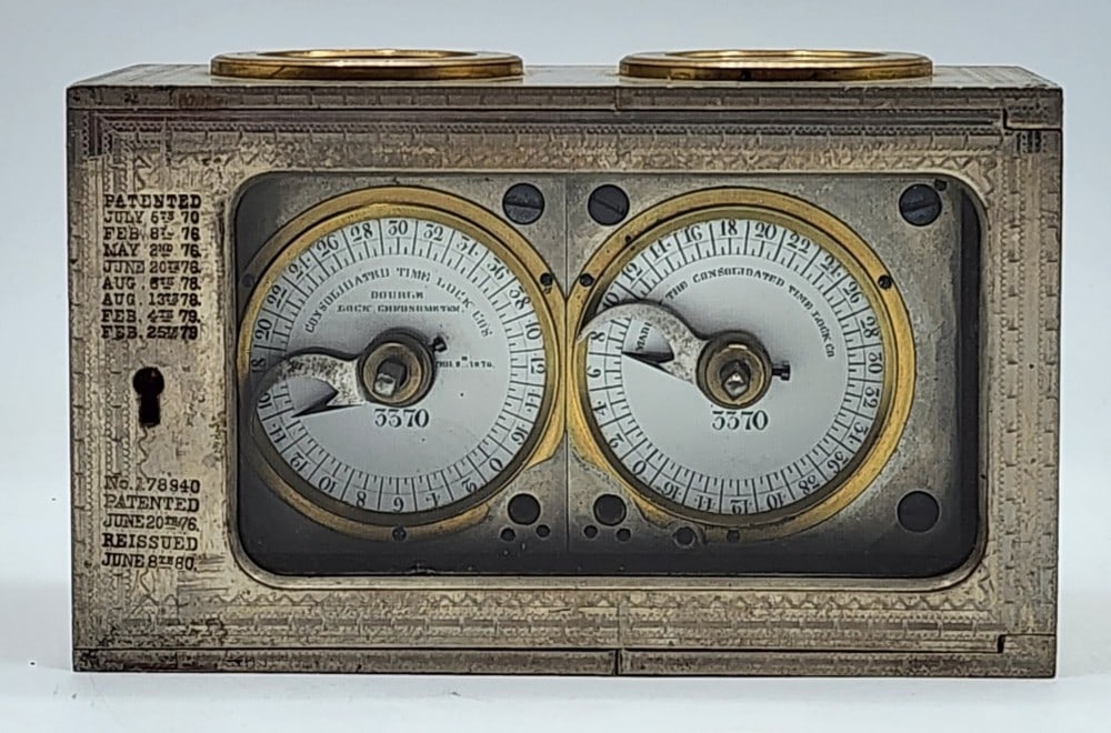 Consolidated Time Lock Co Bank Vault Time Lock: Patented July 5, 1870. Marked 3213. Lock uses 2 independent watch mechanisms to lock the safe at certain times. Light wear in metal due to age and use. Does not include a key. Measures approximately 5