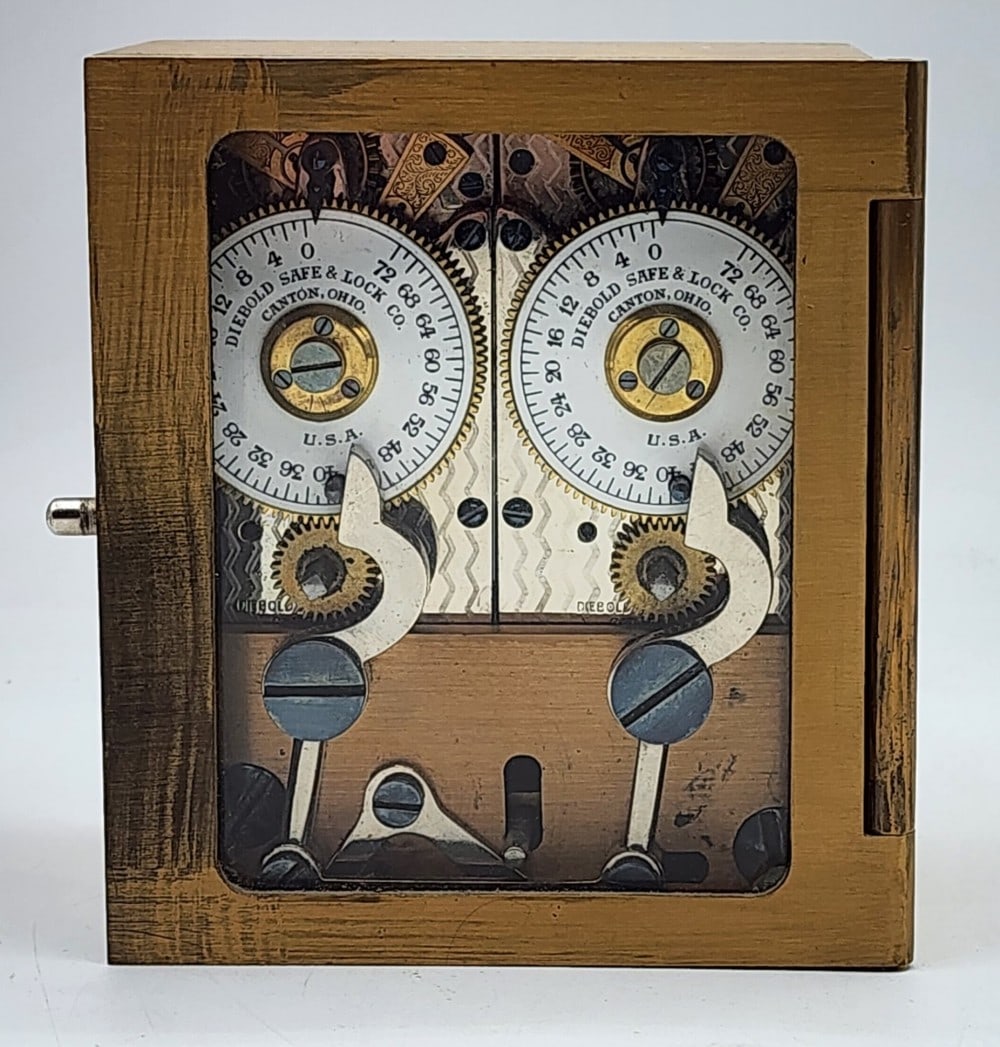 Diebold Safe & Lock Co Bank Vault Time Lock: Diebold is a company from Canton, Ohio. Marked 9132. Lock uses 2 independent watch mechanisms to lock the safe at certain times. Light wear due to age and handling. Does not include a key. Measures ap