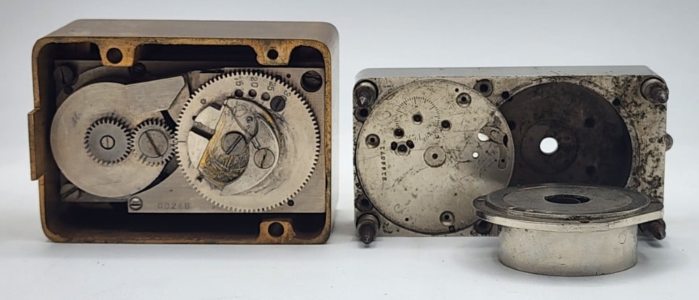 2 Bank Vault Time Locks: Includes 1 Diebold Safe And Lock Co. The other Lock brand is illegible. Locks uses independent watch mechanisms to lock the safe at certain times. Does not include outer case, inner workings only. Do