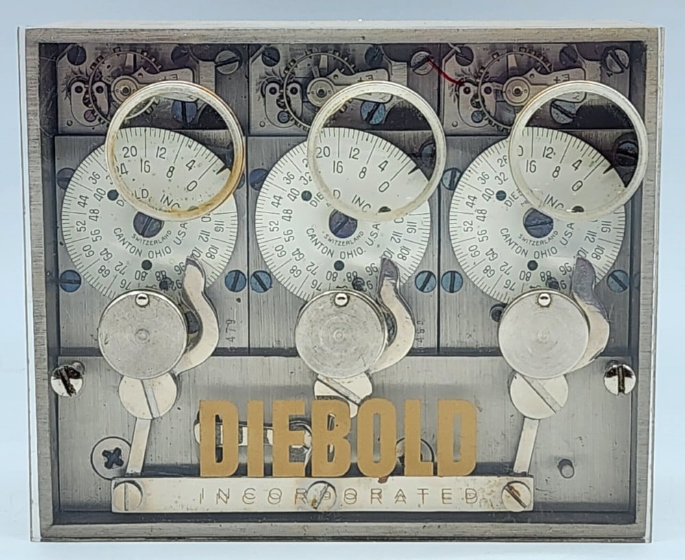Diebold Incorporated Bank Vault Time Lock: Diebold is a company from Canton, Ohio. Lock uses 3 independent watch mechanisms to lock the safe at certain times. The watch mechanisms were made in Switzerland. Light wear on metal due to handling.