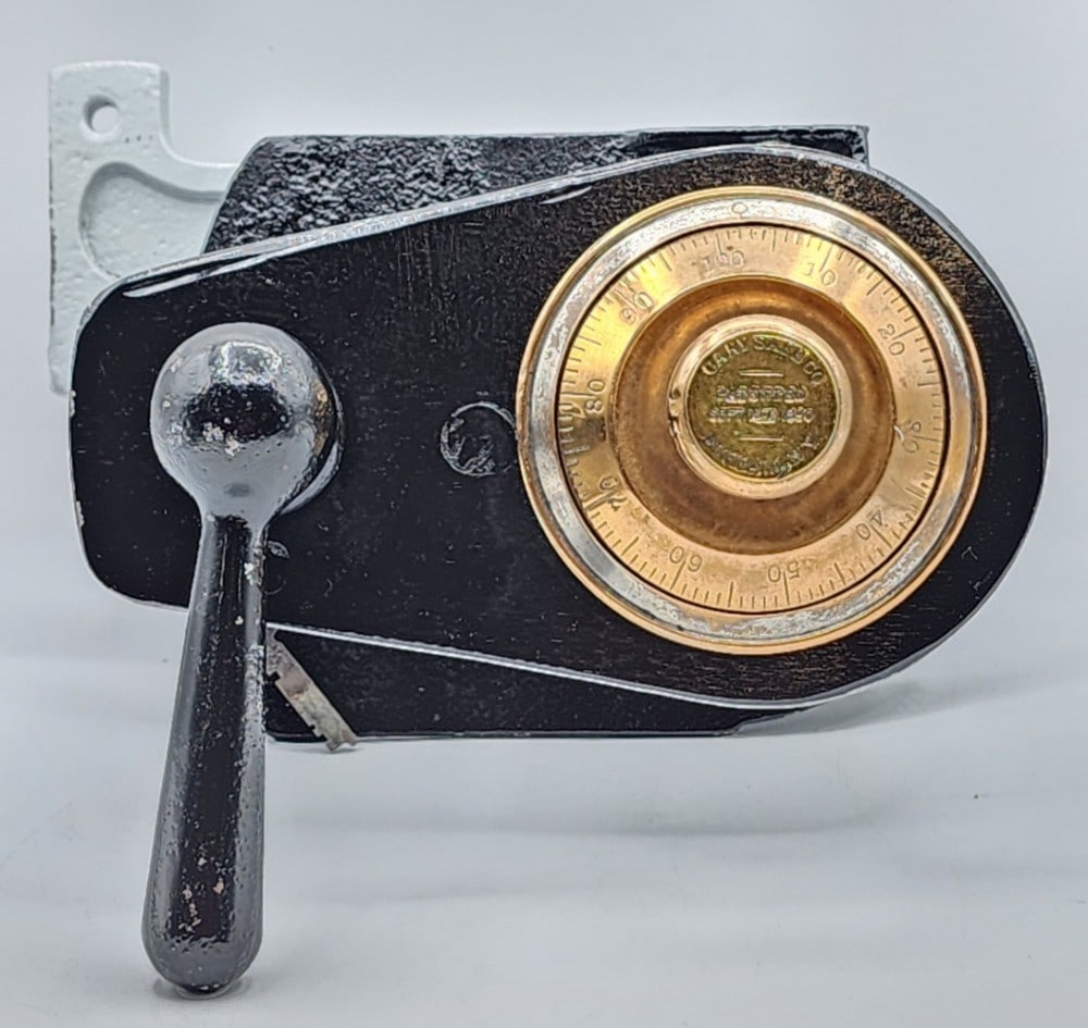 Cary Safe Co Safe Lock Cutaway Mechanism: Cary Safe Co is a company founded in Buffalo, N.Y. The cutaway features a dial combination lock mounted on a black cast metal plate and has a bolt system with 1 locking point. It was patented on Septe