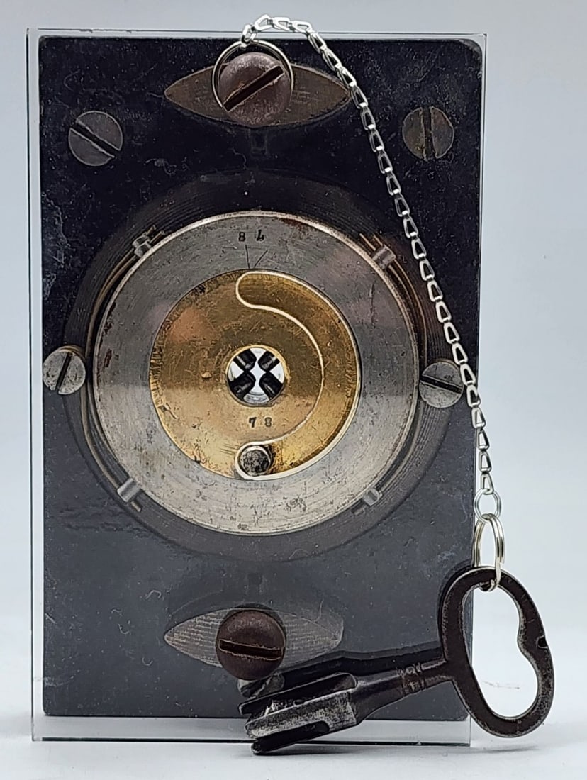 Lock Mechanism Acrylic Display With Key: Lock features a cast metal back plate. Brand is unknown/illegible. The key has a small broken/missing piece. Metal is worn due to age and use. Measures approximately 4_" X 3_" X 6_"