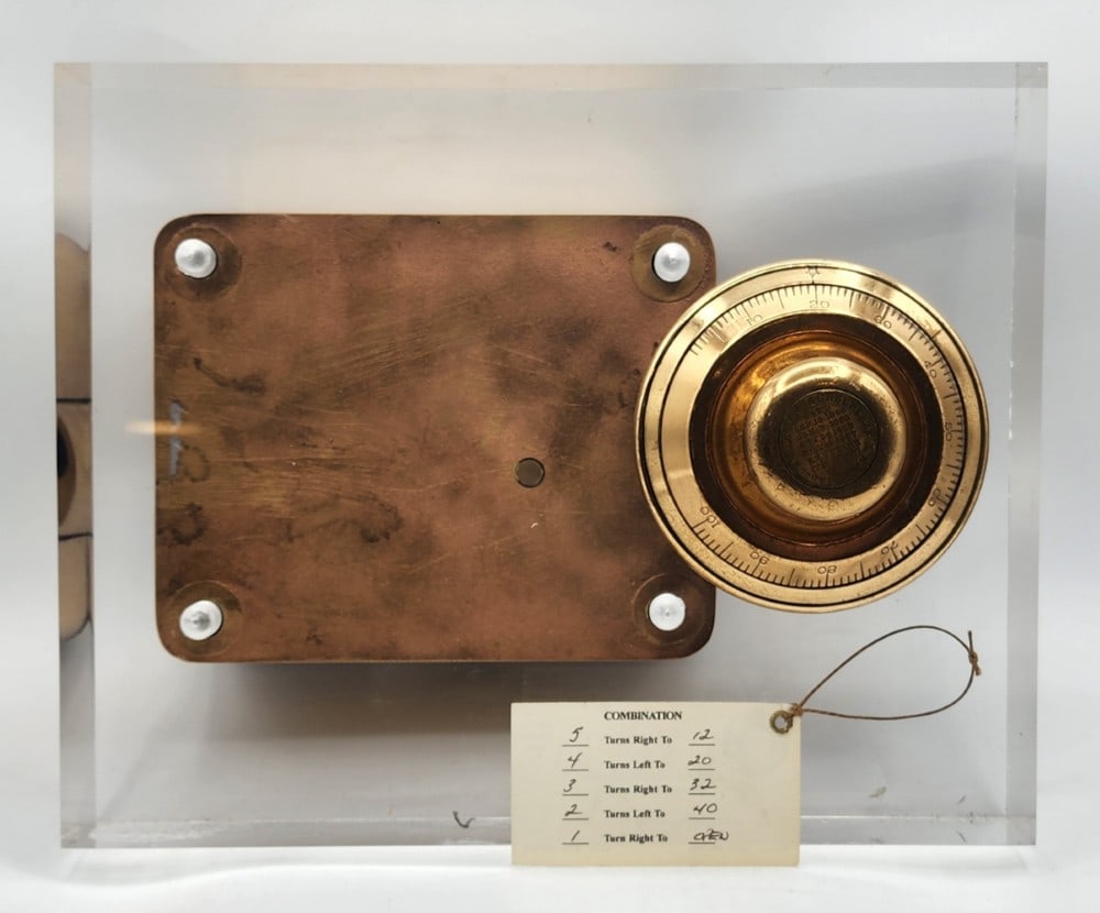 Sargent & Greenleaf Safe Lock Mechanism Acrylic Display: Sargent & Greenleaf is a company based in Rochester N.Y. The mechanism was first patented on September 18, 1860. It features a dial combination lock with a cast metal body. The lock uses a single bolt