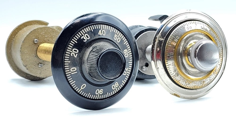 2 Mechanical Safe Combination Dial Lock Mechanisms: Dials are marked 0-99 and 1-100. Mechanisms are encased in cast metal. The locks use single bolt locking point systems. Metal is worn and scuffed due to age and use. Bigger mechanism measures approxim