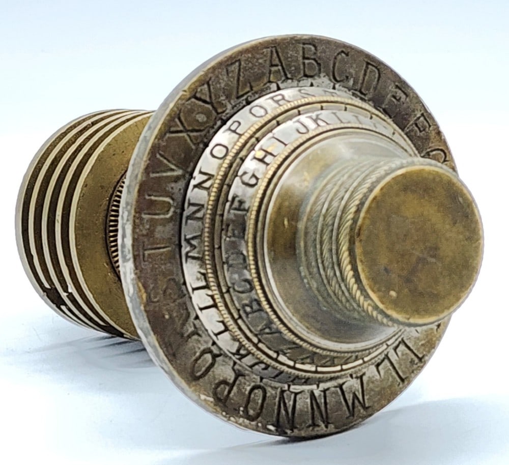 Safe Combination Dial Lock: The dial features 3 sets of A-Z combinations. It includes part of the inner locking mechanism. Metal is worn due to age and use. Measures approximately 4" in diameter and 6_" long