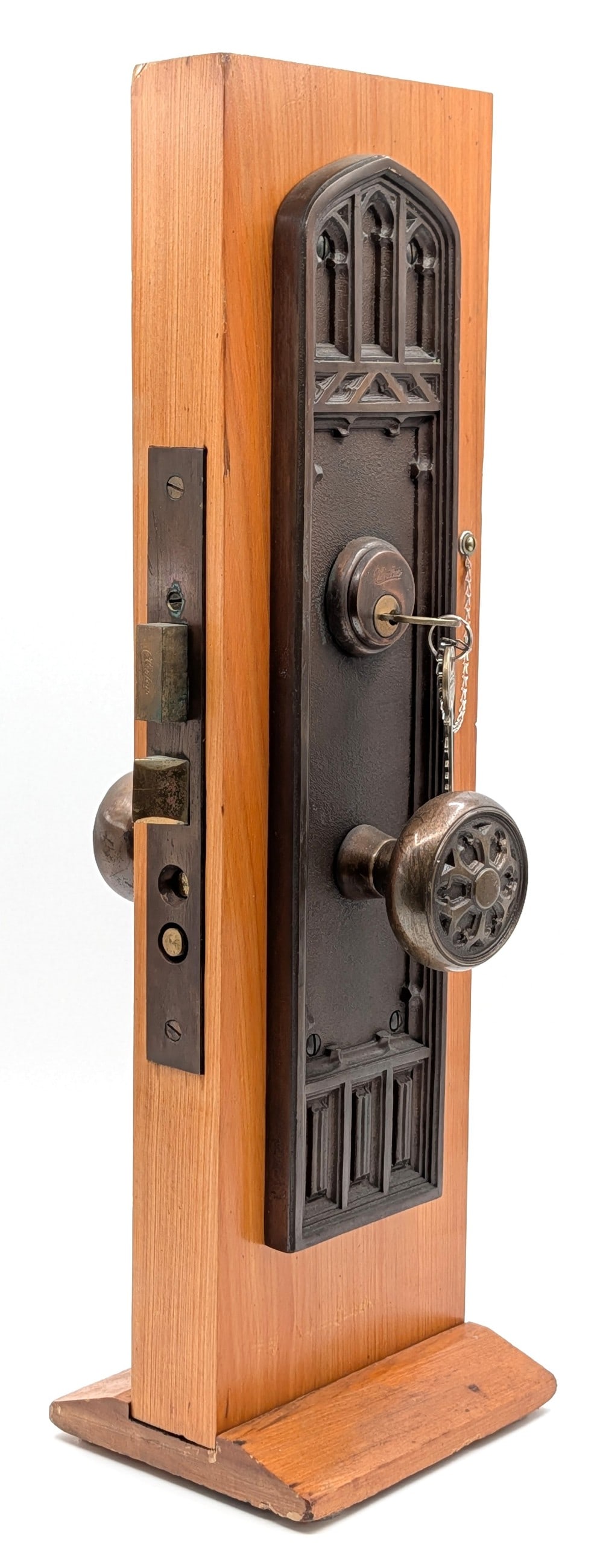 Antique Clinton Bronze Door Mechanism Display: A nice display with cast bronze details on the wooden base. Overall measures 6in wide x 5in deep x 19in tall.