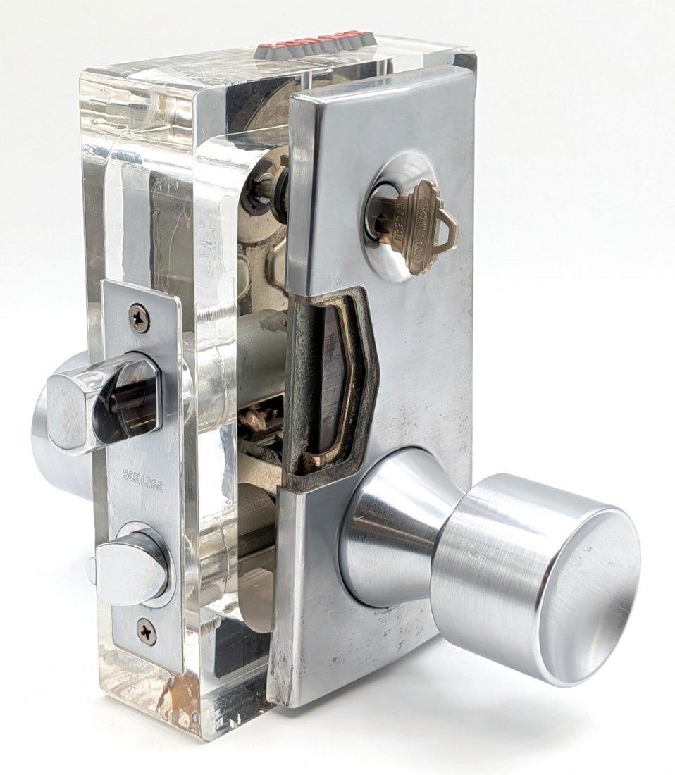 Schlage Door Mechanism Cut Away Salesman Sample: Display is in nice condition with some cracking in the acrylic, and light wear from display. Overall measures 6in wide x 8-1/2in deep x 7-1/2in tall.