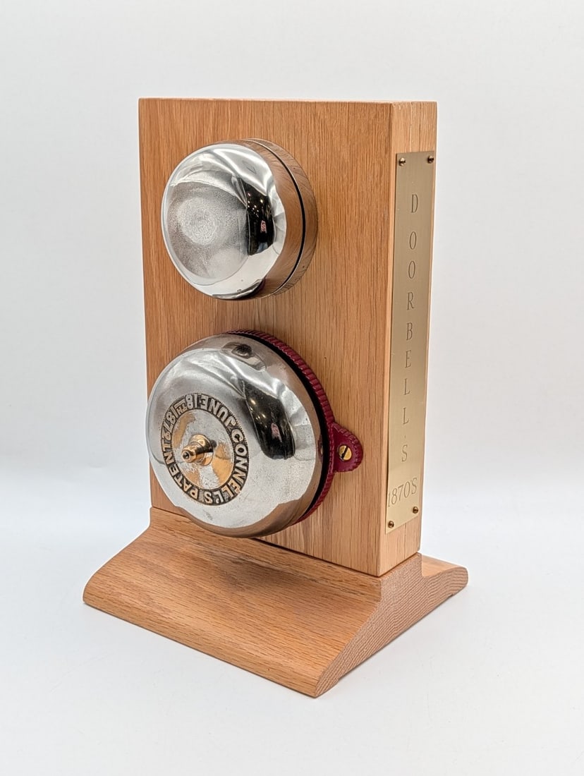 1870's Hand Crank Home Door Bell Display: Display is in nice condition with light wear from display. Overall measures 7in wide x 6-1/2in deep x 12in tall.