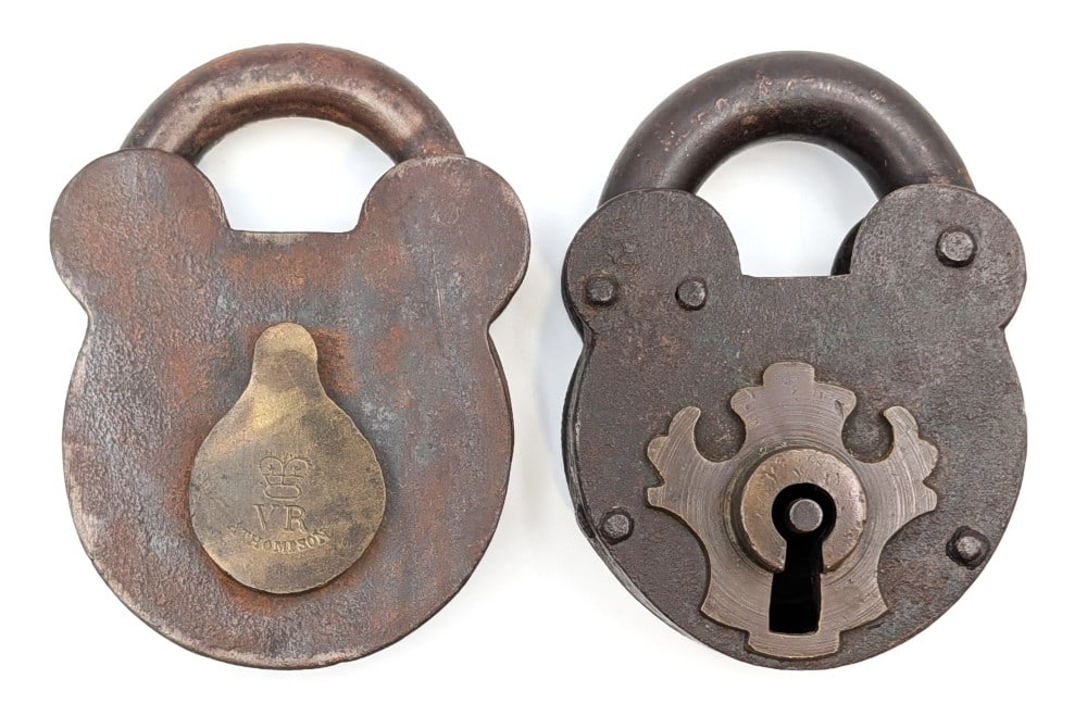 (2) Antique Padlocks: (2) Antique iron and brass padlocks. No keys included. The one is marked "VR A. Thompson" and has a crown on the brass swing door. Both show wear from use and age.